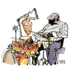Jonathan Blake: Drummer in a flat cap and striped shirt behind his kit, colour