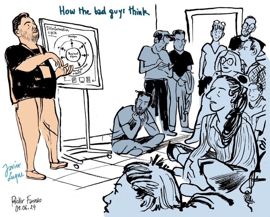 ‘How the bad guys think’: a speaker at a flip chart before a seated audience